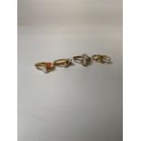 Four unmarked yellow metal rings set with pearls and coral. Two with worn hallmarks. 11.0g Sizes S/