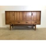A G Plan E. Gomme mid century teak sideboard with sliding concertina doors to two cupboards above