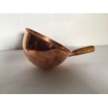 A copper scoop with wooden handleW:33cm x D:22cm x H:12cm