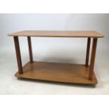 A mid century melamine surfaced two tier table on castors. Stamped Formwood.W:76cm x D:38cm x H: