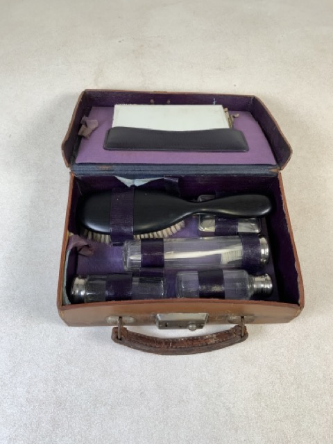 A travelling dressing set with mirror and brush in a leather case. W:24cm x D:17cm x H:7cm