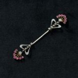 An early 20th century diamond and ruby Jabot pin set throughout with single and old cut diamonds