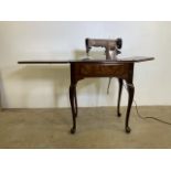 A 201K Singer sewing machine EM618113 with a mahogany table with drop down compartment drawer to