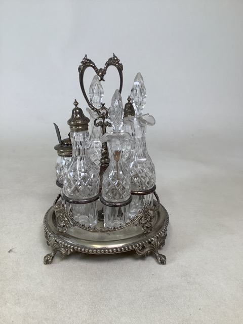 Victorian revolving EPNS condiment set comprising cut glass bottles, a mustard bottle with lid and