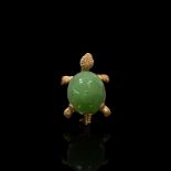 An 18ct gold and jade tortoise brooch. Carved jade body with with 750 marked mount. W:2.6cm x D: