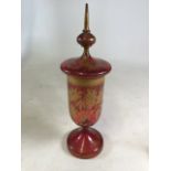 A late 19th century cranberry gilt glass lidded vase with gilt fern leaf decoration .Slight chip to