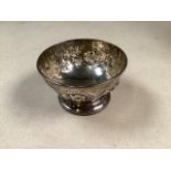 A sterling silver bowl with repousse decoration on circular stepped base. 2.75oz. W:9cm x D:9cm
