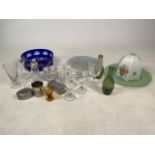 A selection of glassware to include blue glass bowl, green glass plate, green glass bottles and