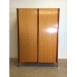 A mid century Teak veneered two tone double wardrobe by Loughborough furniture. Brass hanging