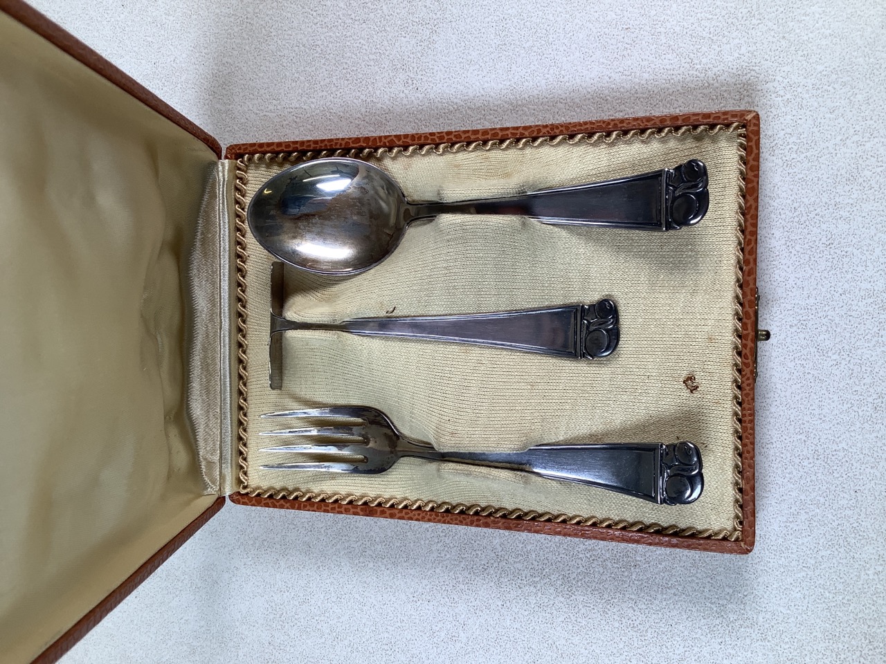 A continental 800 marked Arts and Crafts style silver christening set circa 1905 with stylised