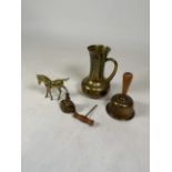 Four brass items to include small jug, two bells, a horse and a wooden corkscrew