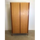 A mid century two tone teak wardrobe by Loughborough furniture, with interior dressing mirror and