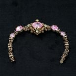 A 19th century foil backed pink topaz and chrysoberyl set Etruscan style bracelet. 19cm