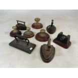 A Collection of metal ware door stops - nine in total including irons and weight.