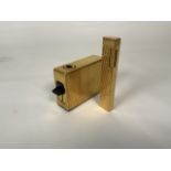 A gold plated Braun engine turned table lighter marked Braun permanent made in W.Germany together