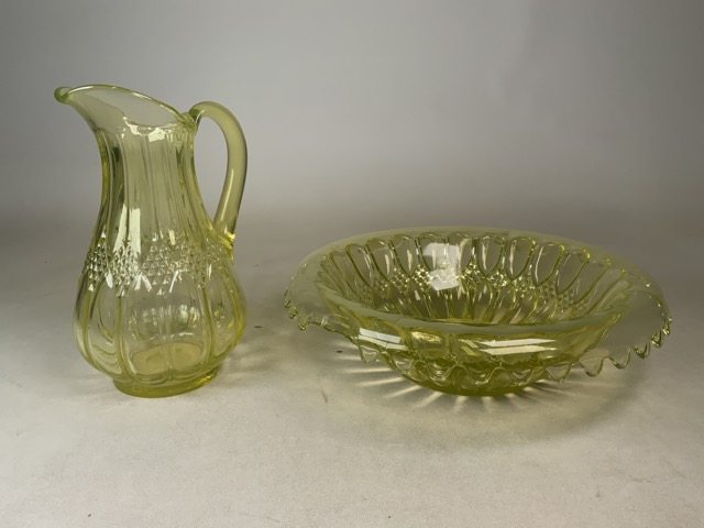 A Uranium yellow glass jug and punch bowl. Jug: H: 31cm. Punch bowl: W:40cm H: 12cm