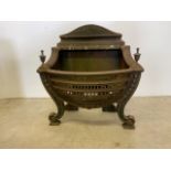 A Victorian cast iron fire basket with later finials.