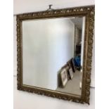 A square bevelled mirror with pierced gilt frame. Late 19th early 20th century. W:72cm x H:77cm