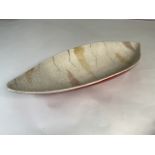 A 1950s Crown Devon boat shaped bowl, red ground with textured interior. W:36cm x D:14cm x H:5cm