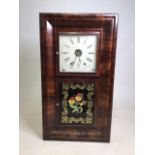 An American mahogany wall clock. With two glazed doors.W:43cm x D:12cm x H:76cm