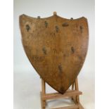 An oak shield shaped wall mounted plaque.W:59cm x H:64cm