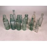 A collection of glass bottles to include four coded bottles from Devon and branded bottles.