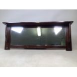 A Liberty and Co Arts and Crafts mahogany overmantel mirror with plate rack above. W:125cm x D:
