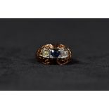 A French 18ct gold, diamond and sapphire ladies dress ring. Central free oval cut sapphire with
