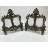 A pair of gilt brass dual aspect easel picture frames topped by classical maiden and putti. W:30cm