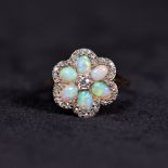 A late 19th early 20th century 18ct gold and platinum diamond and opal flower ring, set throughout