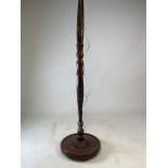 A mahogany Black Forest style floor lamp with carvel detailing of a town landscape. H:150cm (