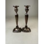 A pair of sterling silver candlesticks marked to base sterling with weighted bases. H:23cm