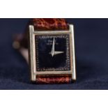 MID SIZE PIAGET EIGHTEEN CARAT GOLD QUARTZ WRIST WATCH the square, black face with gold markers,