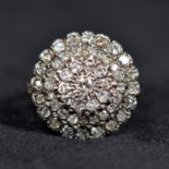 An unmarked 18ct white gold and diamond cluster ring.