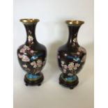 A pair of cloisonne vases on wooden stands W:19cm x D:19cm x H:43cm