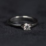 An 18ct white gold single stone diamond ring. Central brilliant cut diamond 0.31cts in a four