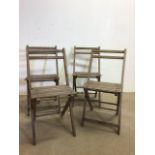 A set of Four folding wooden garden chairs - one with slat missing