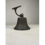 A vintage brass wall hanging ships bell with cast brass bracket. W:15cm x D:15cm x H:20cm