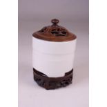 A CHINESE CERAMIC CYLINDRICAL TRIPOD INCENSE BURNER Blanc de Chine, moulded with raised band with