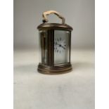 A miniature French gilt brass five glass oval carriage clock. Movement stamped made in France, 11