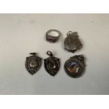 A collection of sterling silver items to include three watch fobs a locket on chain and a three