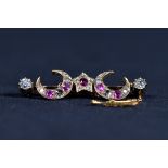 An unmarked precious yellow metal diamond and ruby bar brooch set with two 5mm old cut diamond