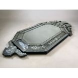 An ornately decorated bevelled mirror.W:70cm x H:138cm