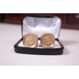 A pair of half sovereign cuff links in a textured 9ct gold mount. 1893 and 1896 in bezel set
