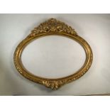 A 19th century giltwood oval frame with carved decoration.W:102cm x H:93cm