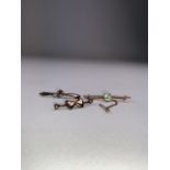 A 15ct gold bar brooch together with a 9ct peridot set bar brooch and an unmarked example. 7.