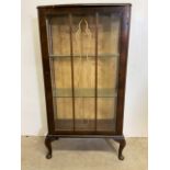 A glazed display cabinet with wallpaper back and two glass shelves. W:60cm x D:29cm x H:113cm