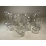 A collection of glassware to include decanters, lidded jars, vases, footed bowl by John Jenkins