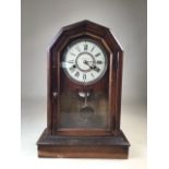 An oak mantle clock dated 1878 with glazed door to front W:32cm x D:42.5cm x H:47cm