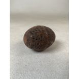 A hand carved coquina nut pocket pomander. W:8cm.